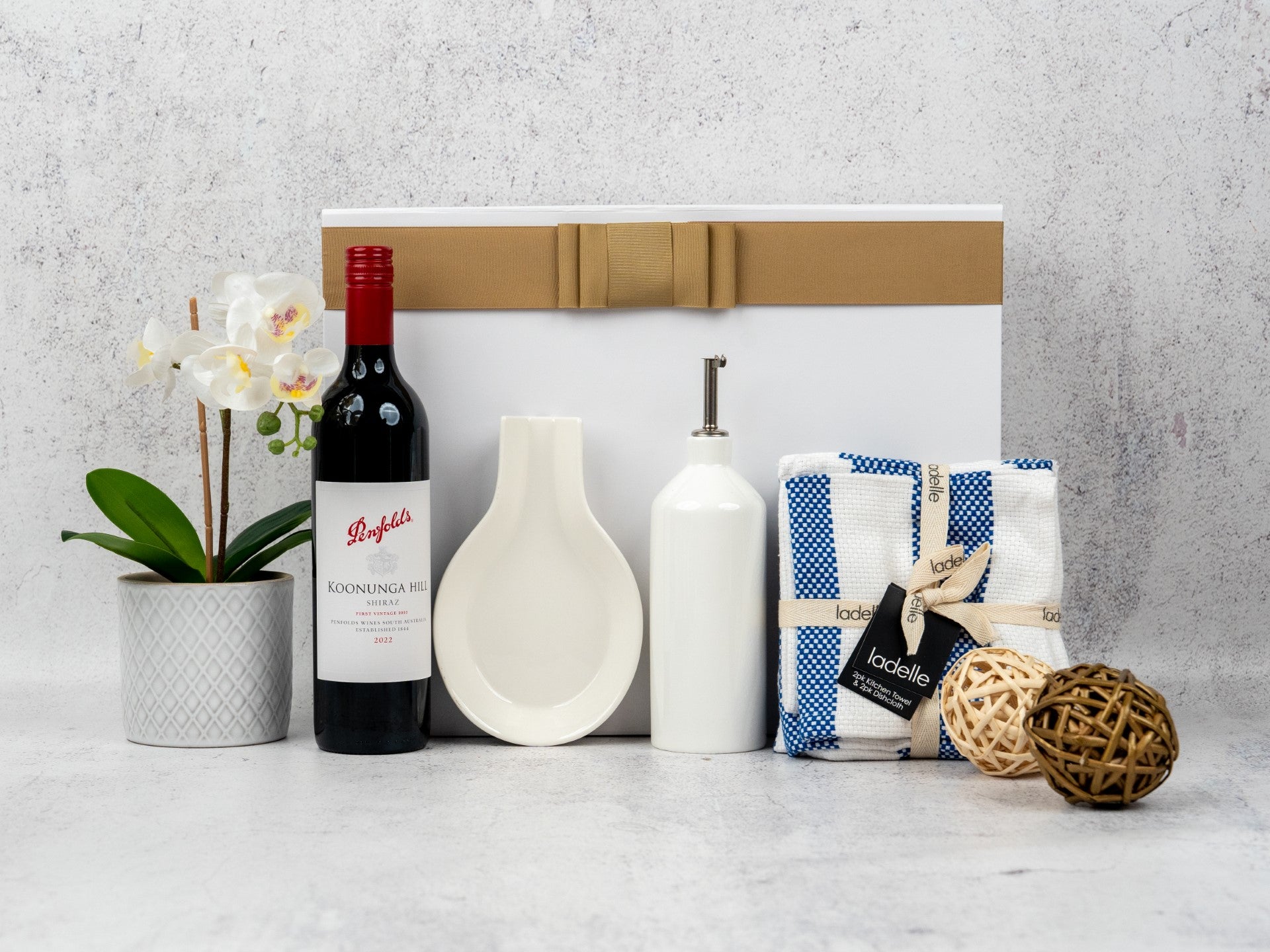 Elevate your kitchen with this Culinary Essentials Hamper, featuring select wines and stylish cooking accessories!