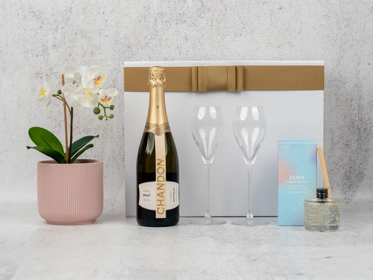 Elegant Champagne Delight Hamper: curated wines, aromatic diffuser, and chic glass flutes for sophisticated tastes.