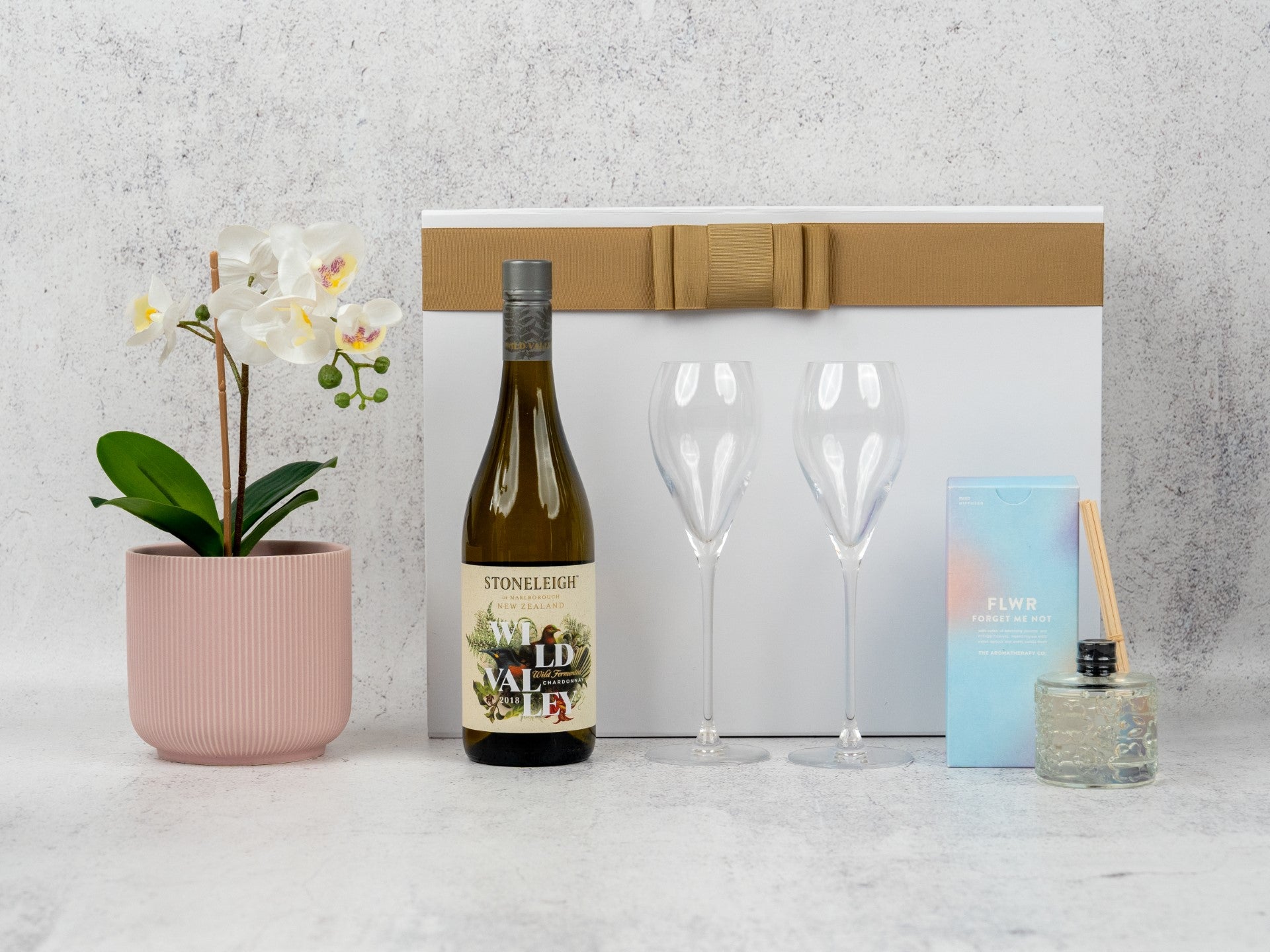 Elegant Champagne Delight Hamper: curated wines, aromatic diffuser, and chic glass flutes for sophisticated tastes.