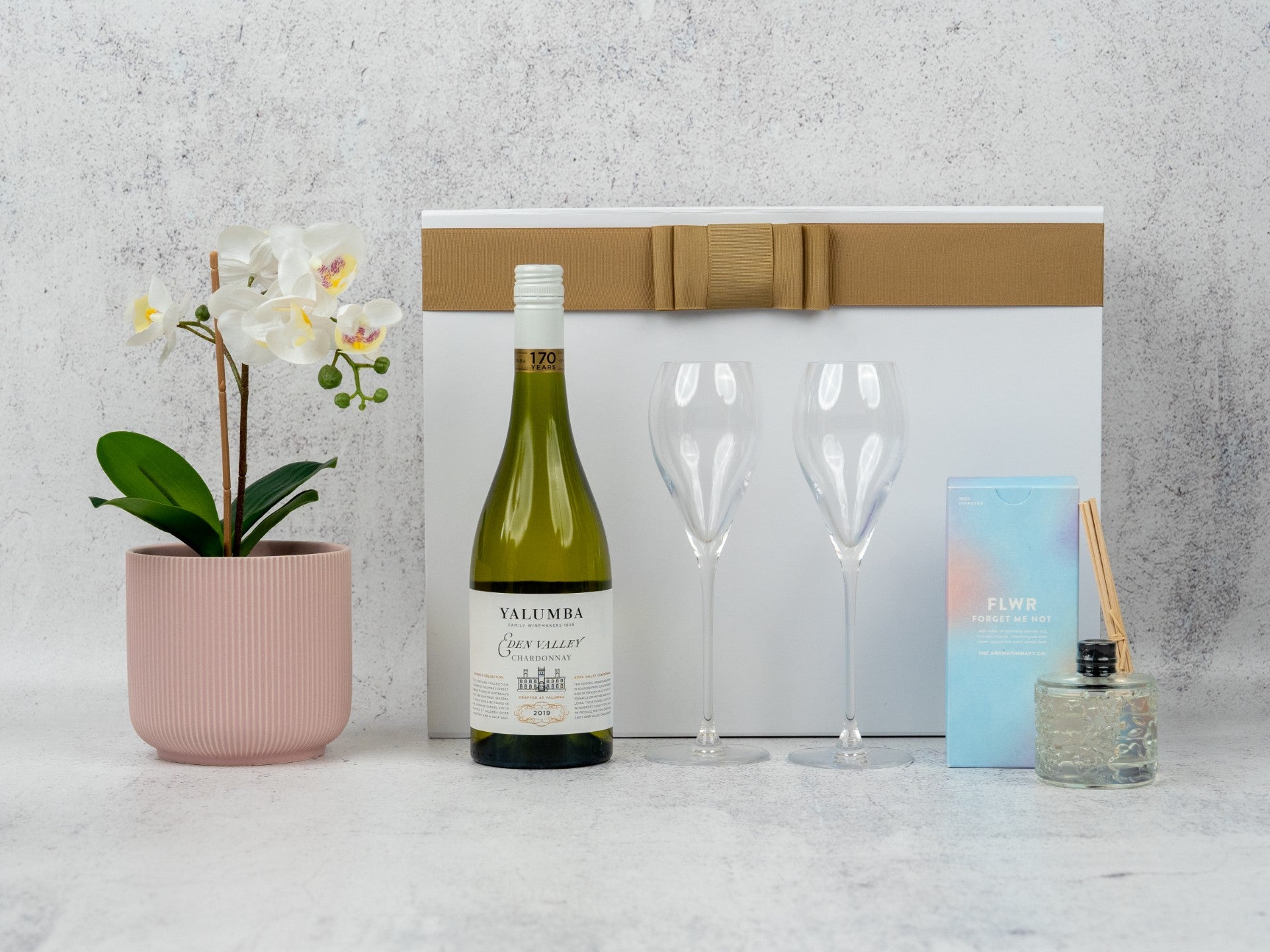 Elegant Champagne Delight Hamper: curated wines, aromatic diffuser, and chic glass flutes for sophisticated tastes.